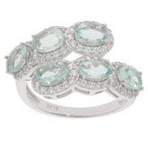 Elegant sterling silver ring featuring multiple oval blue aquamarine gemstones surrounded by sparkling accents.